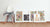 Five of our framed posters standing against a white wall next to a chair. Three of the posters are from the Alphabet Series, one is from the Animal Letters series, and the last one is Luna, a Single Collage.