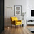 The Illustrator poster hung on a white wall behind a canary-yellow lounge chair.